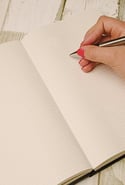 person writing on grid paper