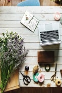 Wooden desk with spring flowers and decorations on it