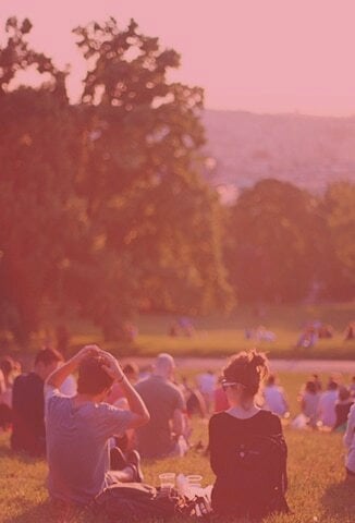 Group of people sitting outside on a hill