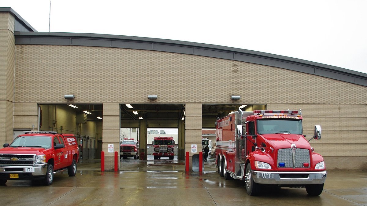 Fire engines parked in the bays of a fire station