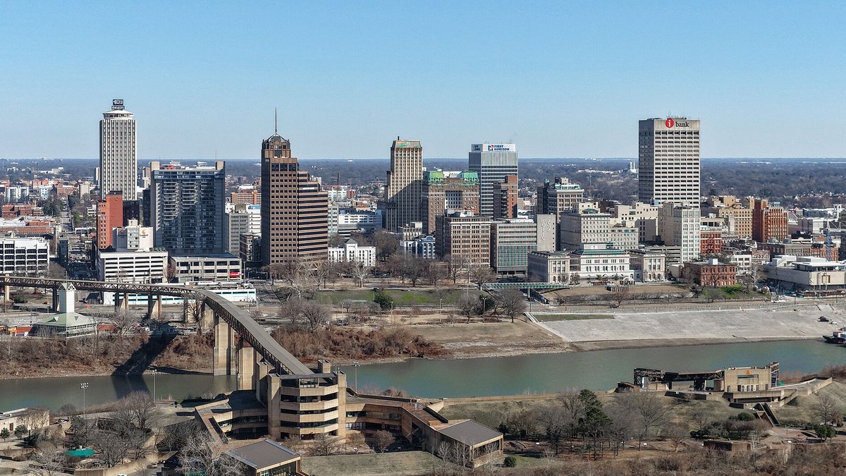 Aerial view of the downtown Memphis skyline along the Mississippi River on a clear, sunny day